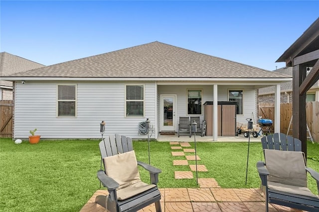 rear view of house featuring a patio and a yard