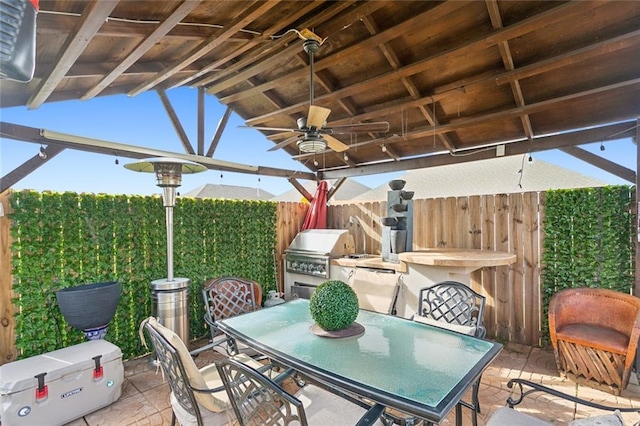 view of patio with ceiling fan and area for grilling