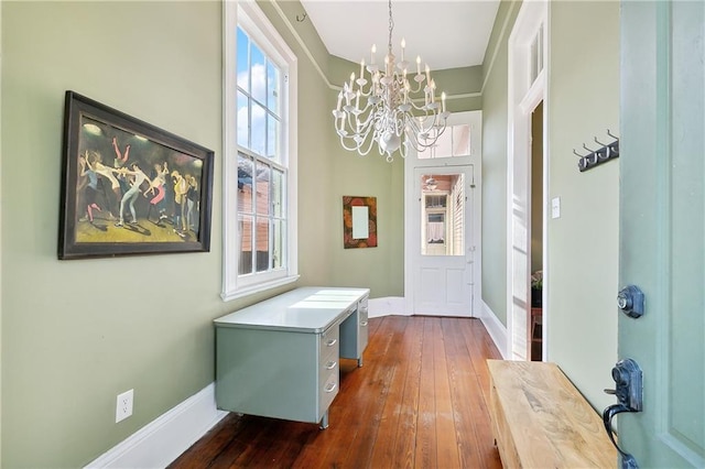 entryway with a chandelier and dark wood-type flooring