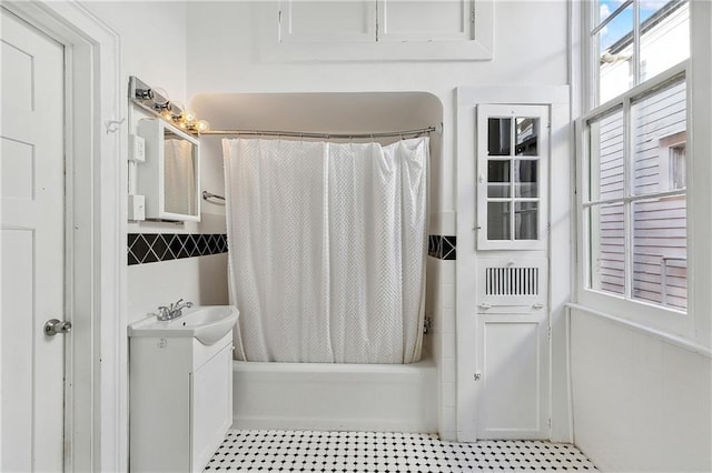 bathroom with shower / tub combo with curtain and vanity