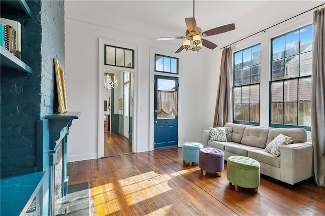 living room featuring ceiling fan and hardwood / wood-style floors