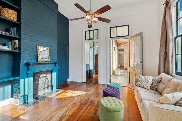 interior space with wood-type flooring, ceiling fan, and built in features