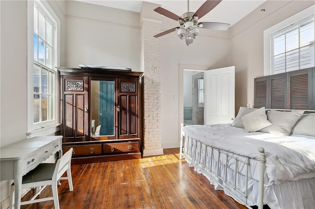 bedroom featuring ceiling fan, wood-type flooring, and connected bathroom