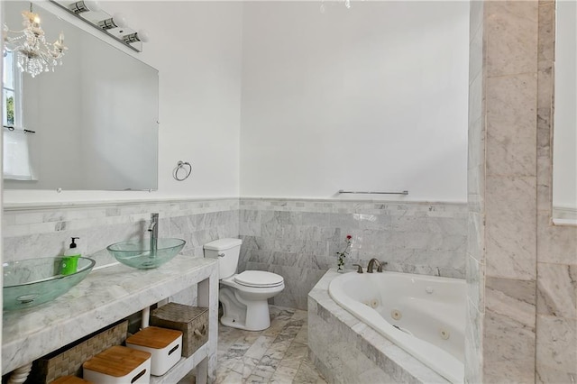 bathroom featuring toilet, a bath, tile walls, and sink