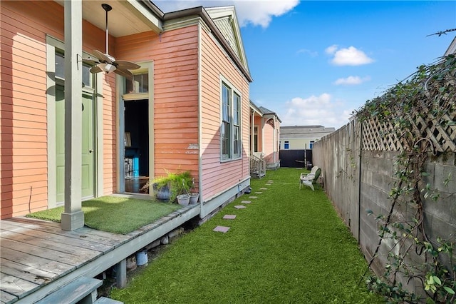 view of property exterior featuring a deck and a yard