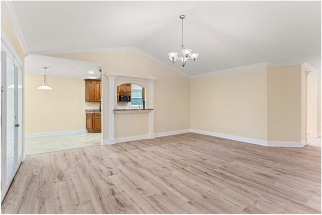 unfurnished living room featuring an inviting chandelier, ornamental molding, vaulted ceiling, and light hardwood / wood-style flooring