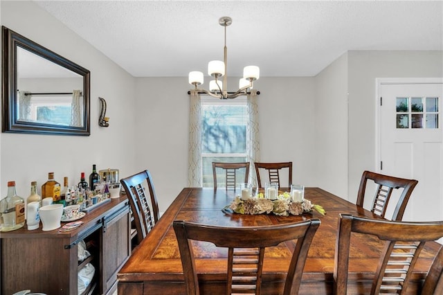 dining room with a textured ceiling and an inviting chandelier