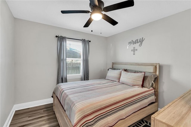 bedroom with dark wood-type flooring and ceiling fan