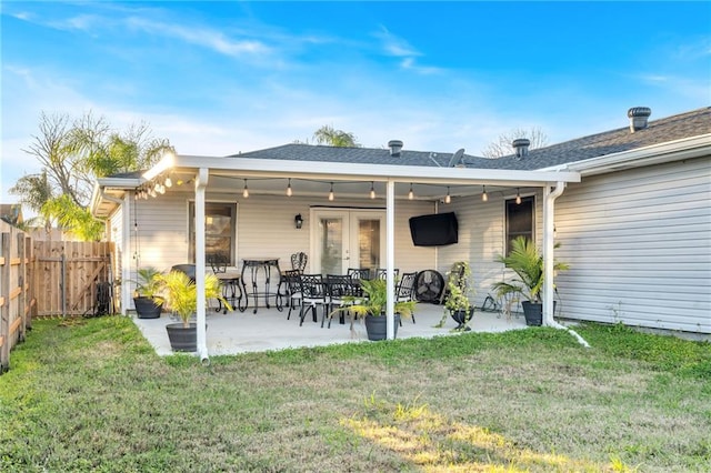 back of house with a patio, french doors, and a yard