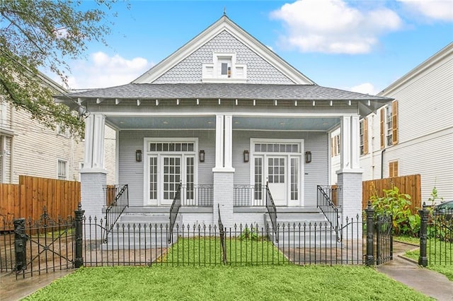 view of front of home featuring a front yard and covered porch