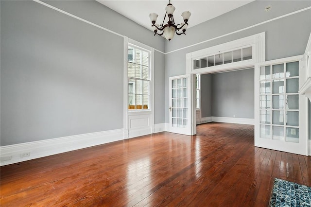 interior space with hardwood / wood-style flooring and a chandelier