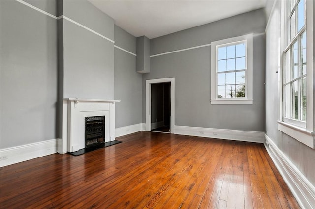 unfurnished living room with wood-type flooring