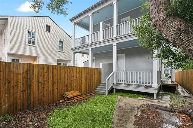 back of house featuring a balcony