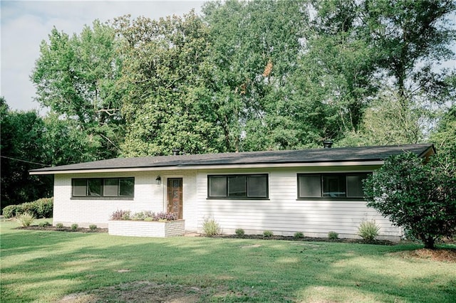 ranch-style home with a front lawn