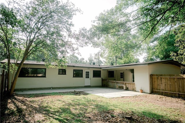 back of property with a patio