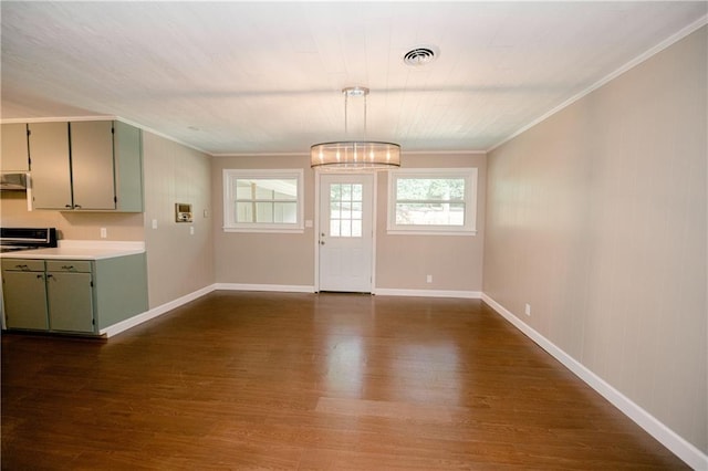 interior space featuring an inviting chandelier, ornamental molding, and dark hardwood / wood-style floors