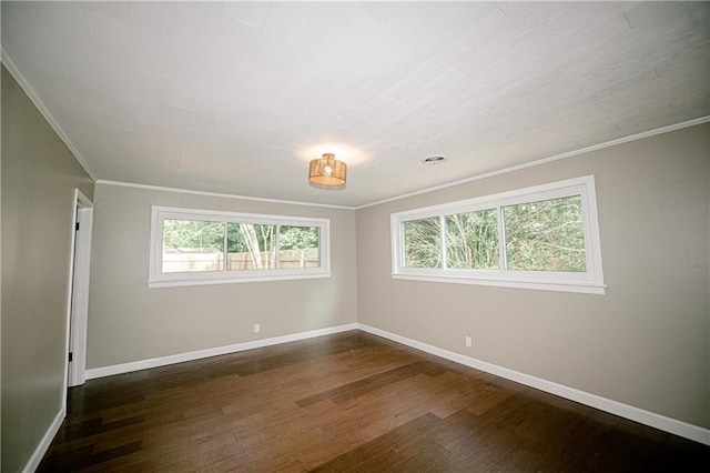 unfurnished room with ornamental molding and dark wood-type flooring