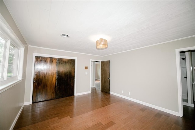 unfurnished bedroom featuring crown molding and dark hardwood / wood-style floors