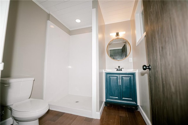 bathroom with toilet, a shower, wood-type flooring, and vanity