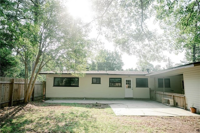 back of property with a patio