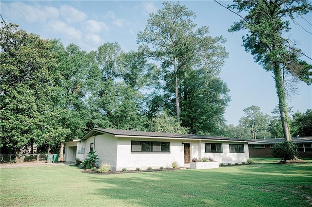 ranch-style home featuring a front yard and a garage