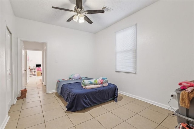 bedroom featuring ceiling fan and light tile patterned floors