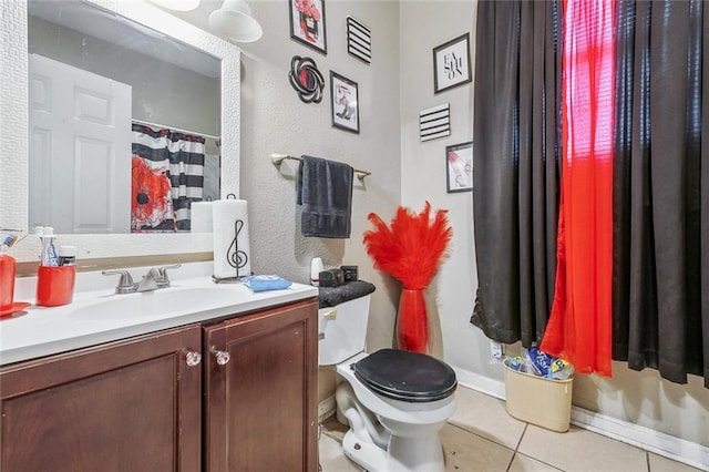 bathroom with toilet, tile patterned floors, and vanity