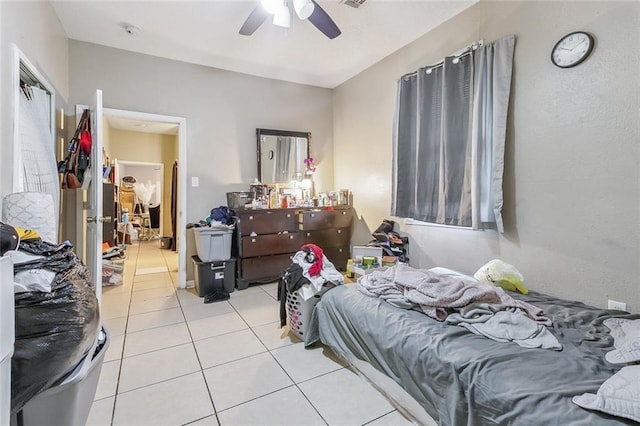 bedroom with ceiling fan and light tile patterned floors