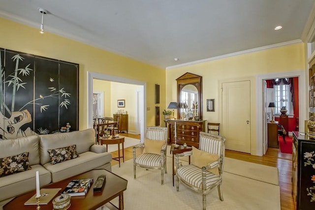 living room featuring light wood-type flooring and ornamental molding