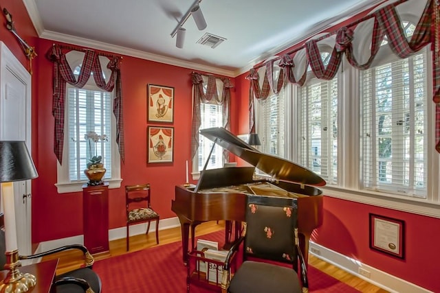 miscellaneous room with crown molding and hardwood / wood-style flooring