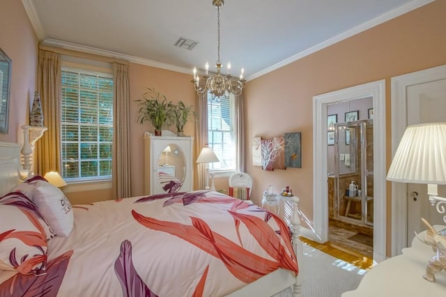 bedroom featuring a chandelier, connected bathroom, hardwood / wood-style flooring, and ornamental molding