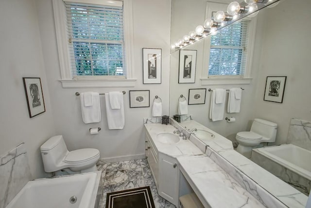 bathroom with toilet, a bath, and vanity