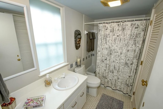 full bathroom with shower / tub combo, tile patterned flooring, vanity, and toilet