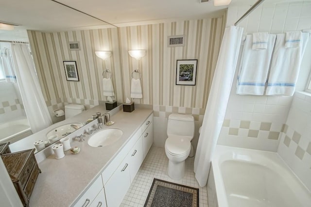 bathroom with toilet, tile patterned floors, and vanity