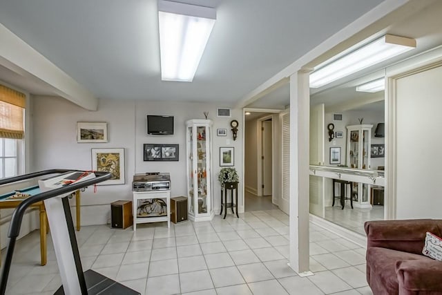 exercise room featuring light tile patterned floors