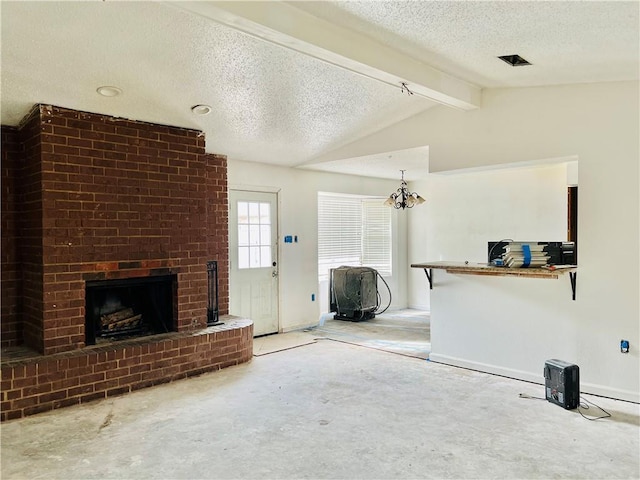 unfurnished living room featuring a textured ceiling, a chandelier, lofted ceiling with beams, and a fireplace