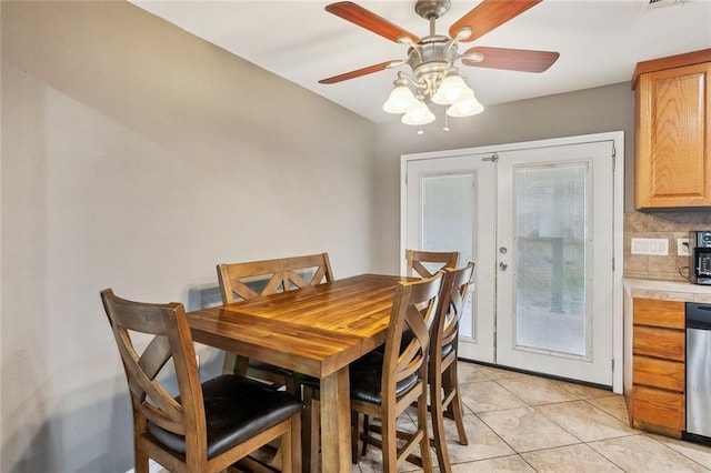 tiled dining space with french doors and ceiling fan