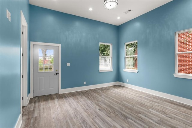 entryway with light hardwood / wood-style flooring and a healthy amount of sunlight