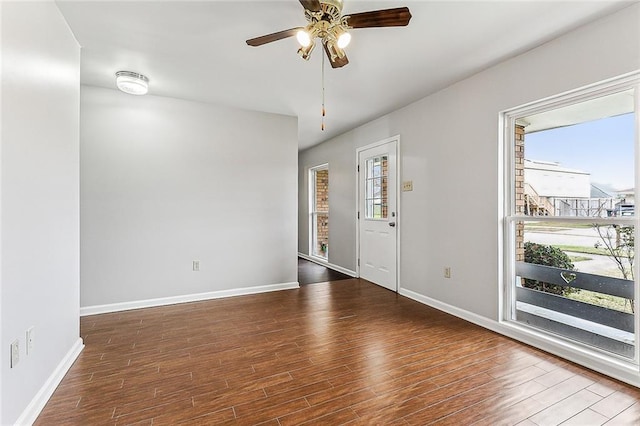 unfurnished room with ceiling fan and dark hardwood / wood-style floors