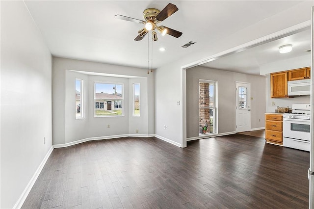 interior space with ceiling fan and dark hardwood / wood-style flooring