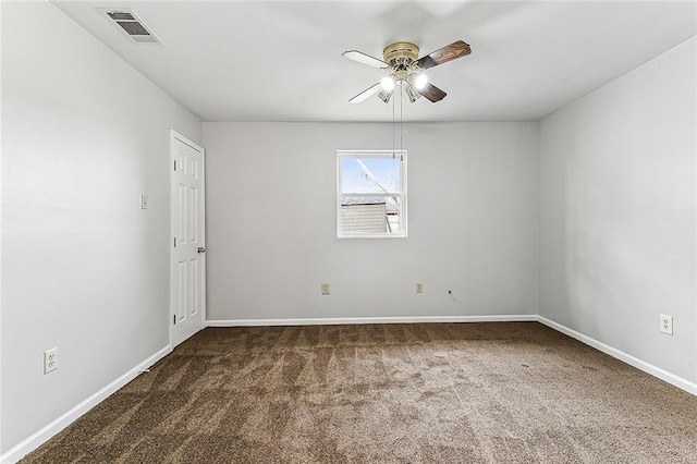 spare room with dark carpet and ceiling fan