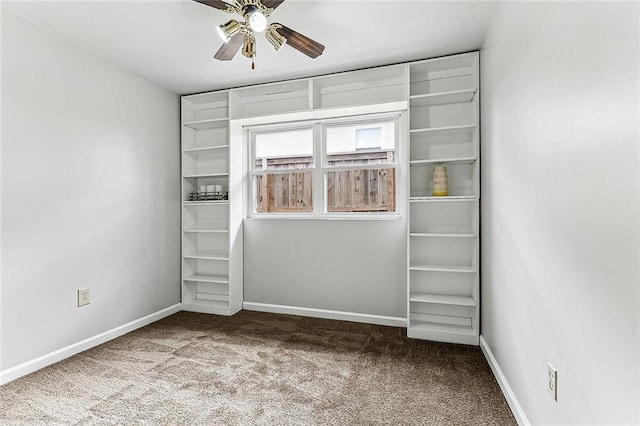 empty room with ceiling fan and carpet