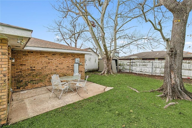 view of yard with a shed and a patio area