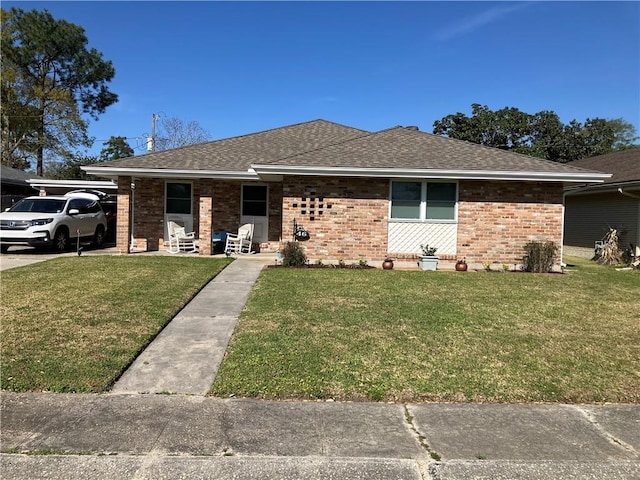 46 Donelon Dr, Harahan, LA 70123 - view of front of property featuring brick siding, a shingled roof, and a front yard