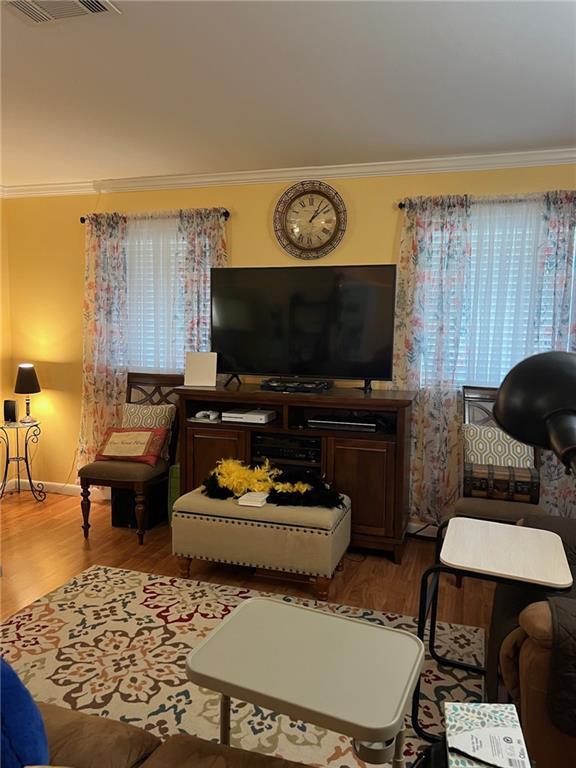 living room featuring ornamental molding and hardwood / wood-style floors