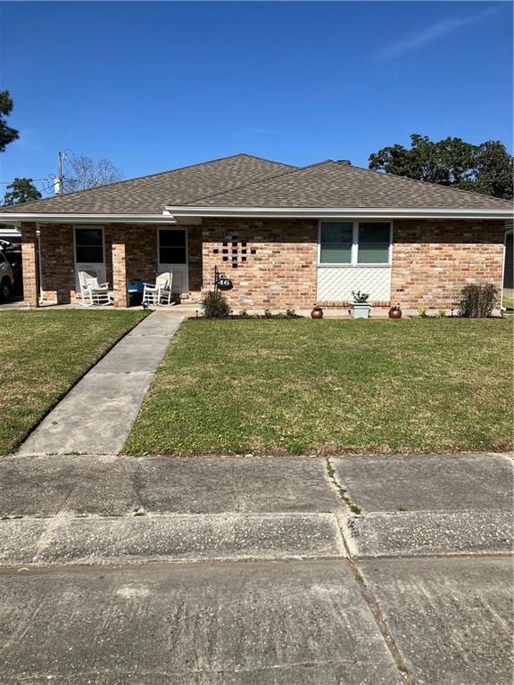 46 Donelon Dr, Harahan, LA 70123 - view of front of home with a front lawn, brick siding, and a shingled roof