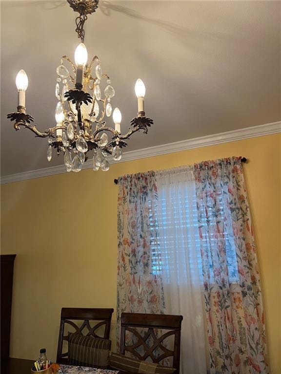 interior details with ornamental molding and a notable chandelier