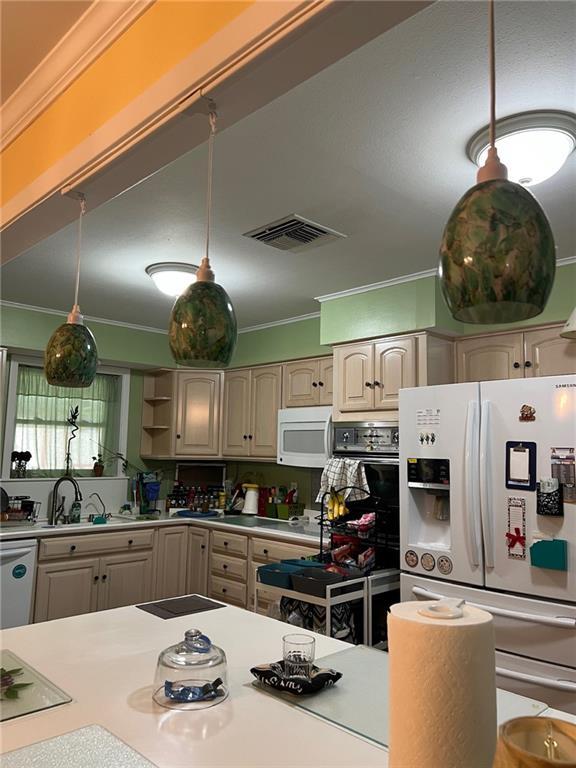 46 Donelon Dr, Harahan, LA 70123 - kitchen featuring white appliances, crown molding, and visible vents