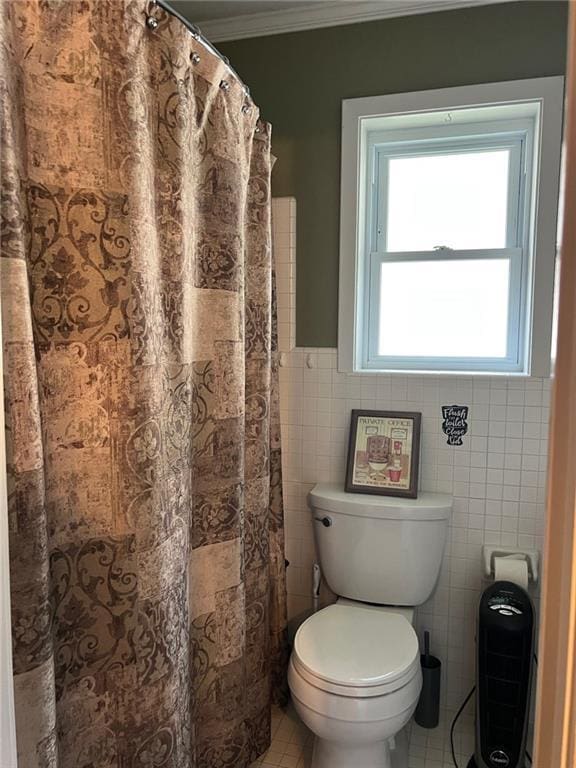 bathroom featuring tile walls, toilet, ornamental molding, and tile patterned floors