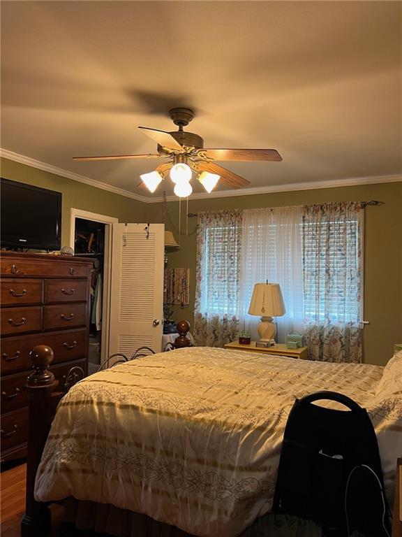 46 Donelon Dr, Harahan, LA 70123 - bedroom featuring a closet, crown molding, and a ceiling fan